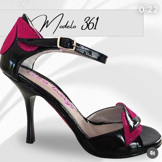 Elegant black high heel shoe with pink bow and ankle strap.