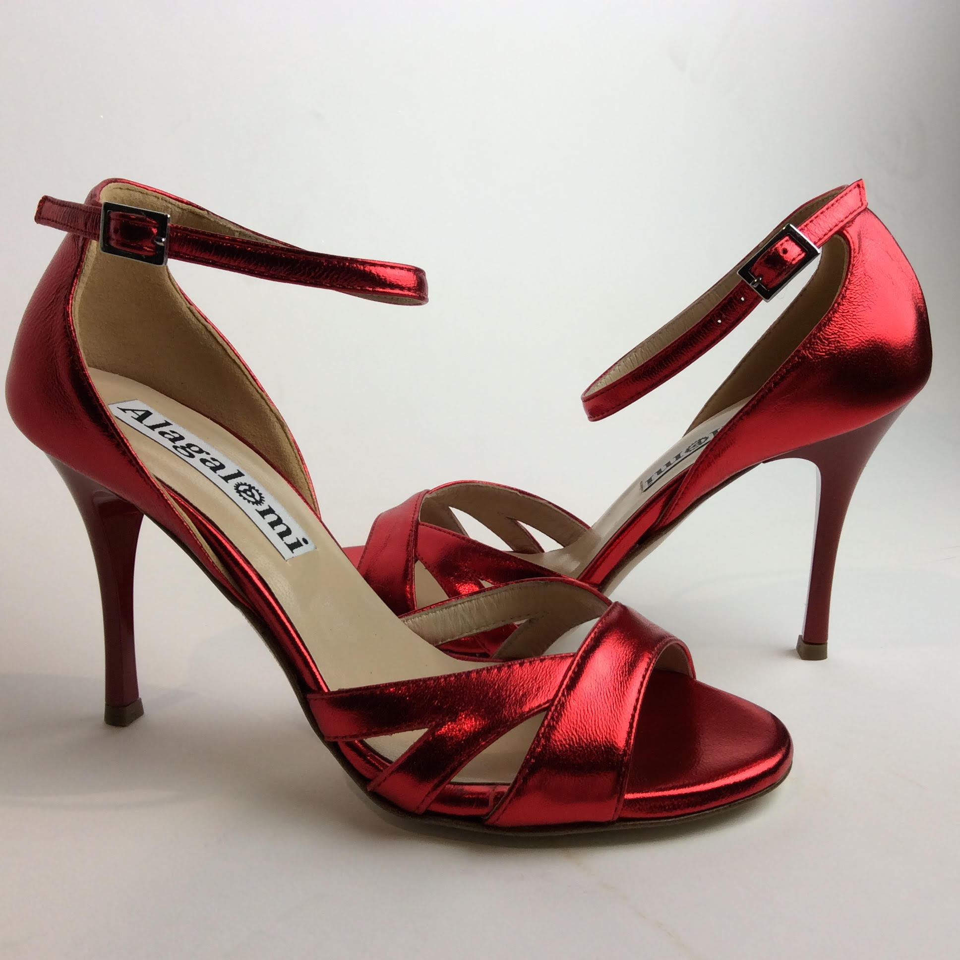Shiny red high-heeled shoes with ankle straps.