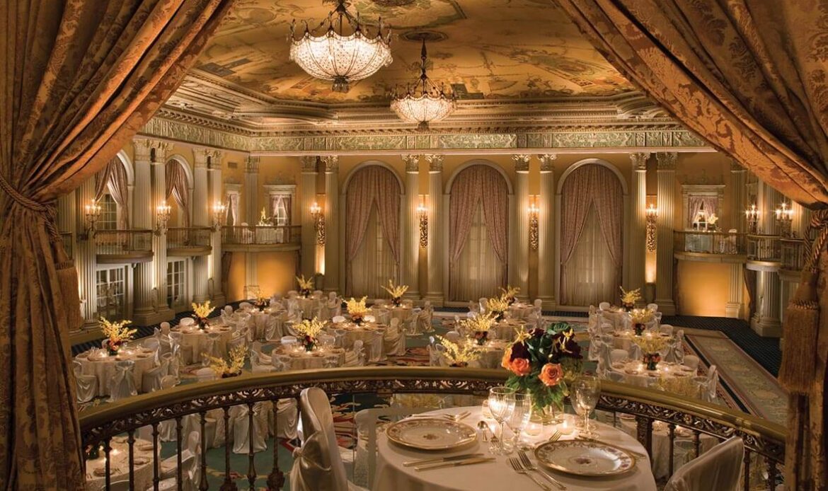Elegant banquet hall with warm lighting and lavish table settings.