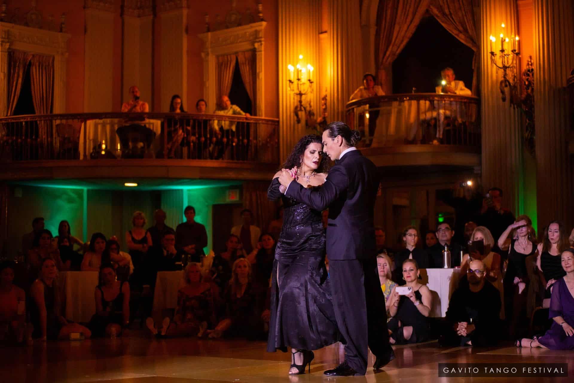 Couple dancing passionately in an elegant ballroom.