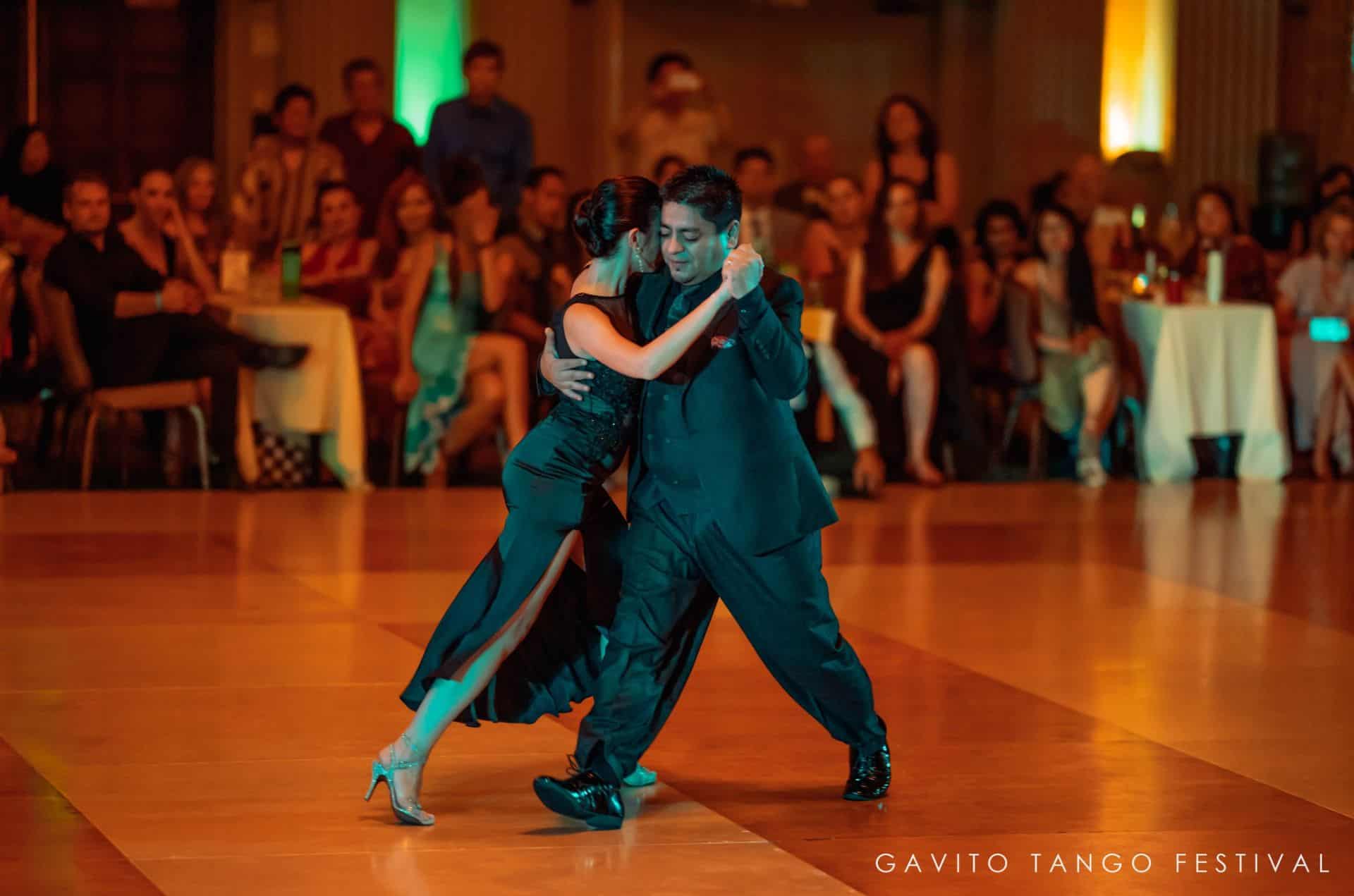 Two dancers passionately performing a tango in a vibrant setting.