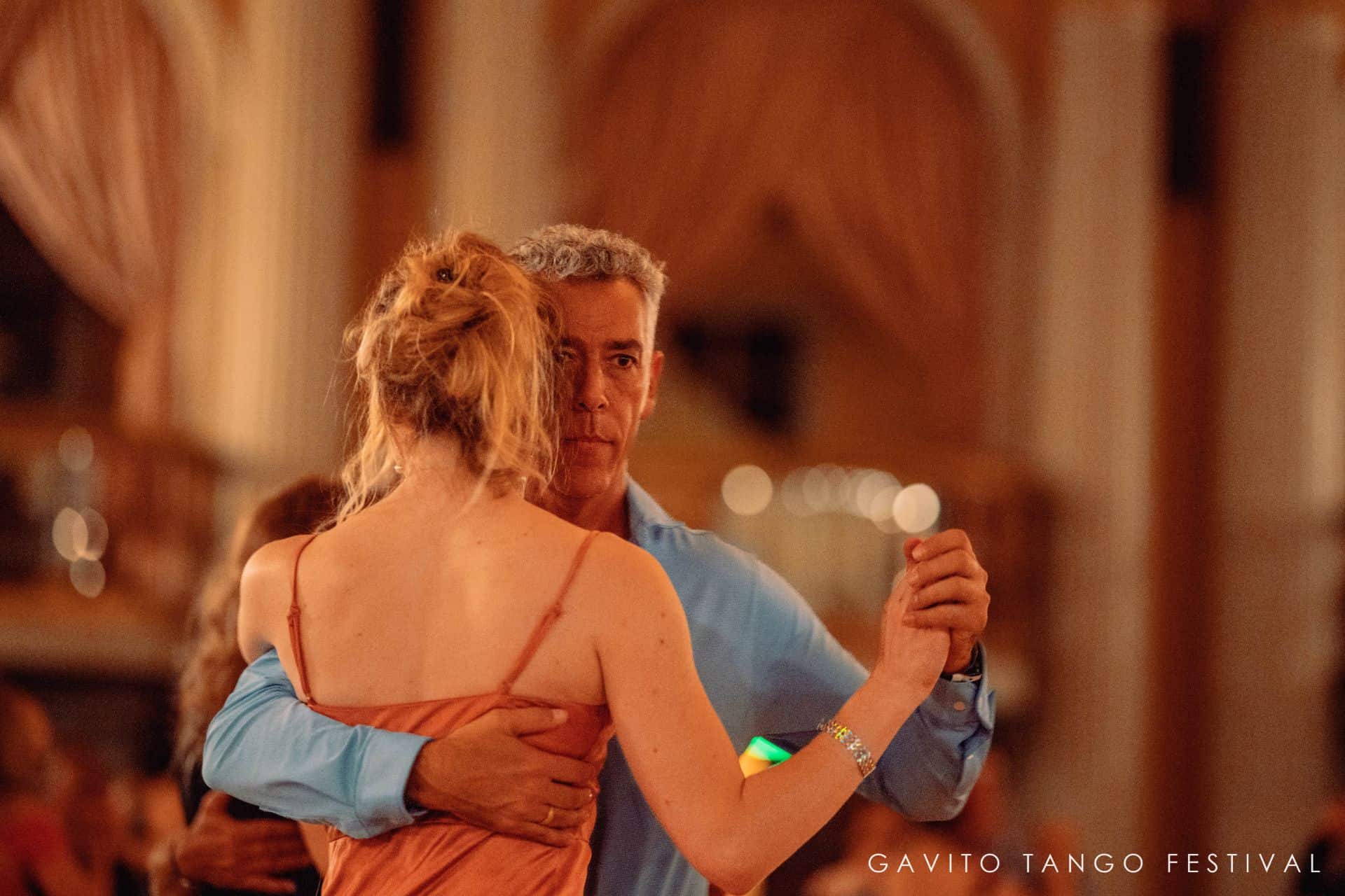 Couple dancing closely at a formal event.