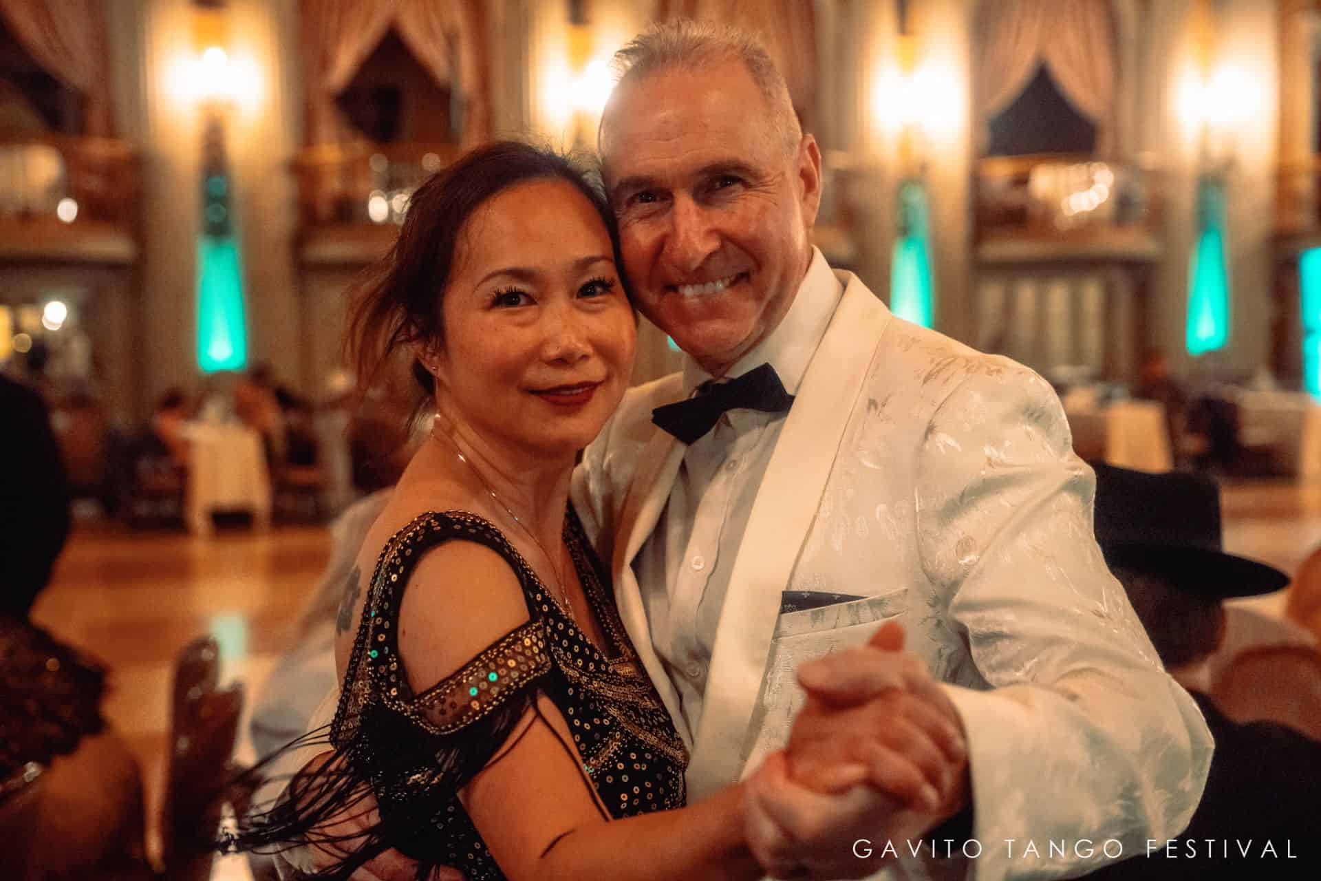 A couple sharing a joyful moment at a lively event.