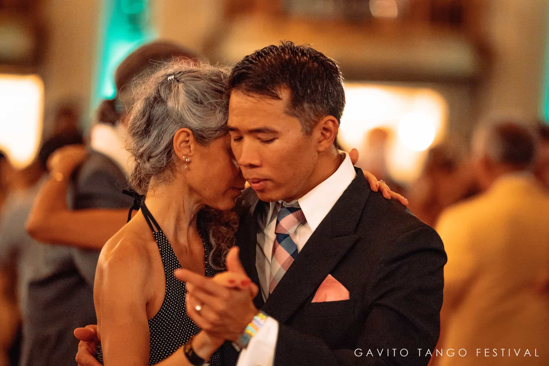 A couple sharing a romantic dance at a formal event.