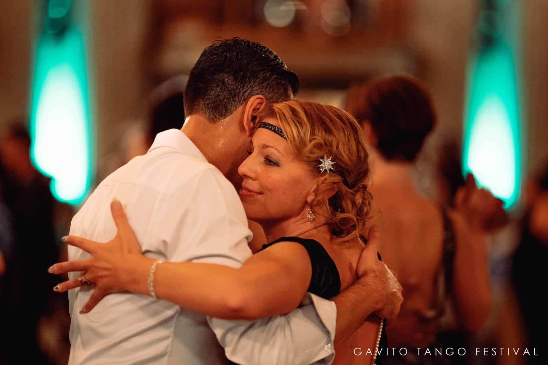 Couple embracing tenderly at a social event.