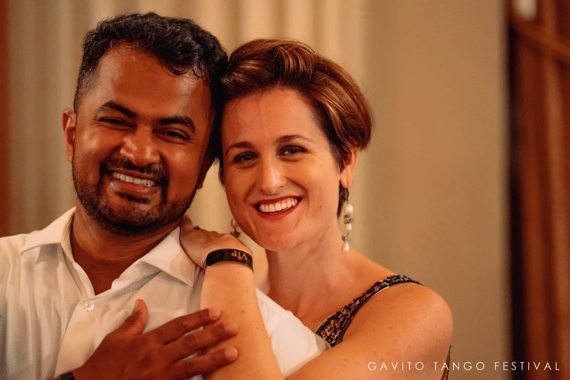 Smiling couple posing closely together indoors.