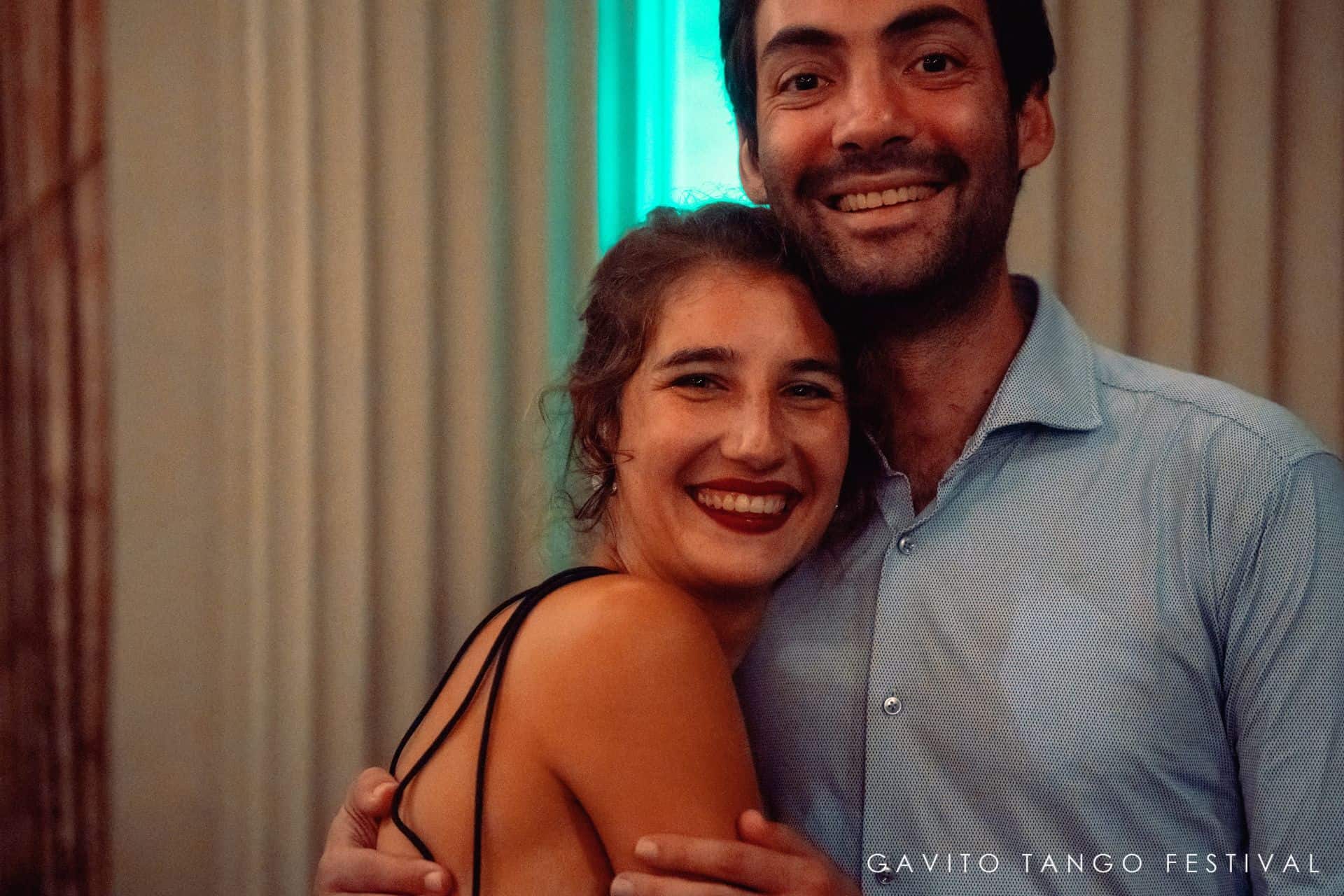A joyful couple smiling and hugging indoors.