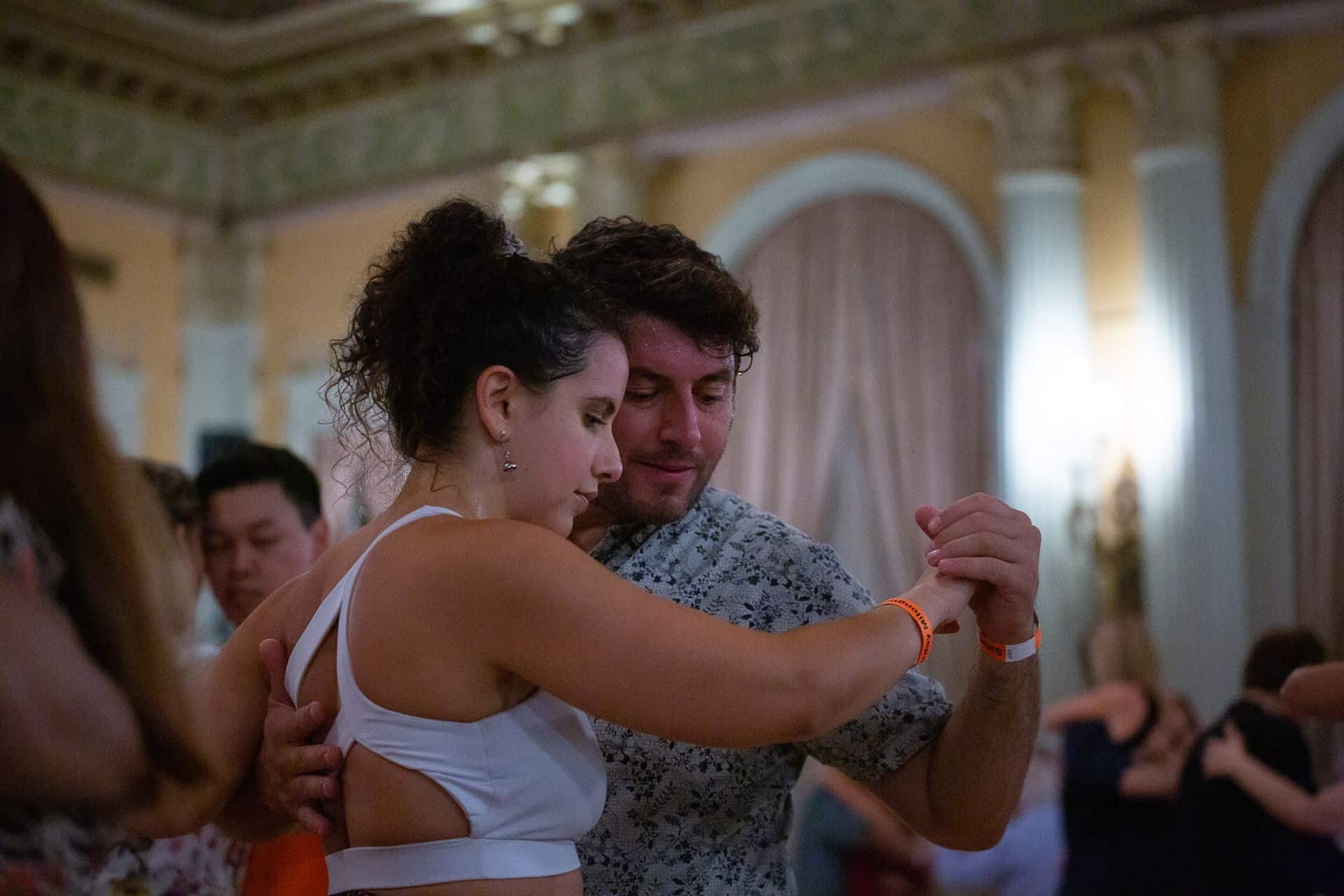 Couple dancing joyfully at a celebration.