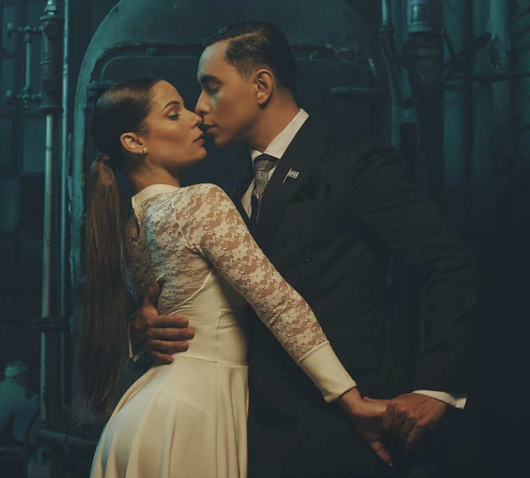 Couple sharing a romantic moment in elegant attire.