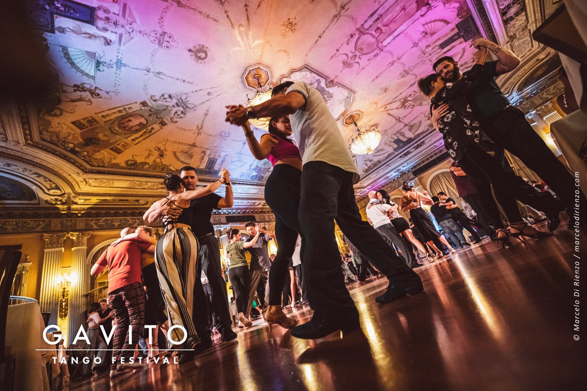 A lively wedding dance with the bride and groom surrounded by guests.