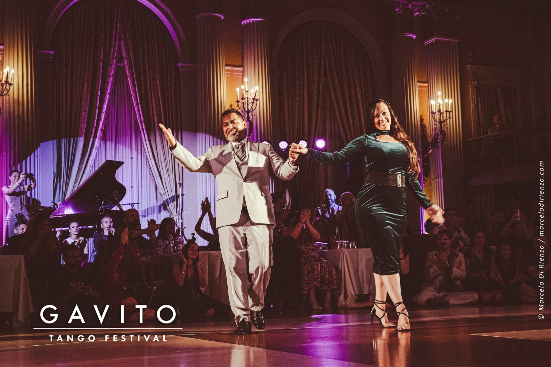 A lively ballroom dance performance with elegant costumes and dramatic lighting.