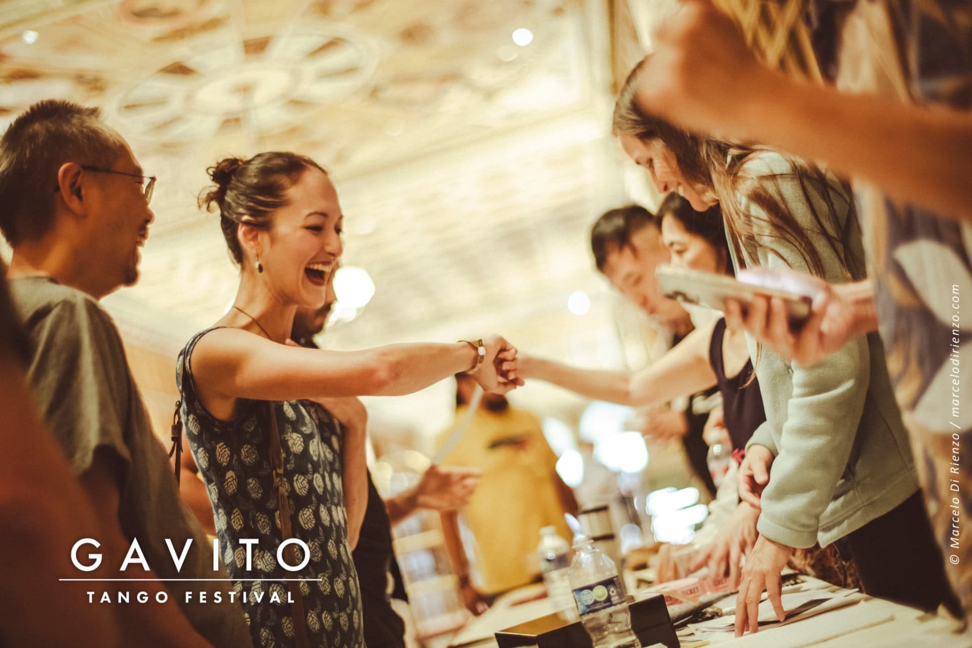 A lively gathering with people enjoying drinks and conversation.