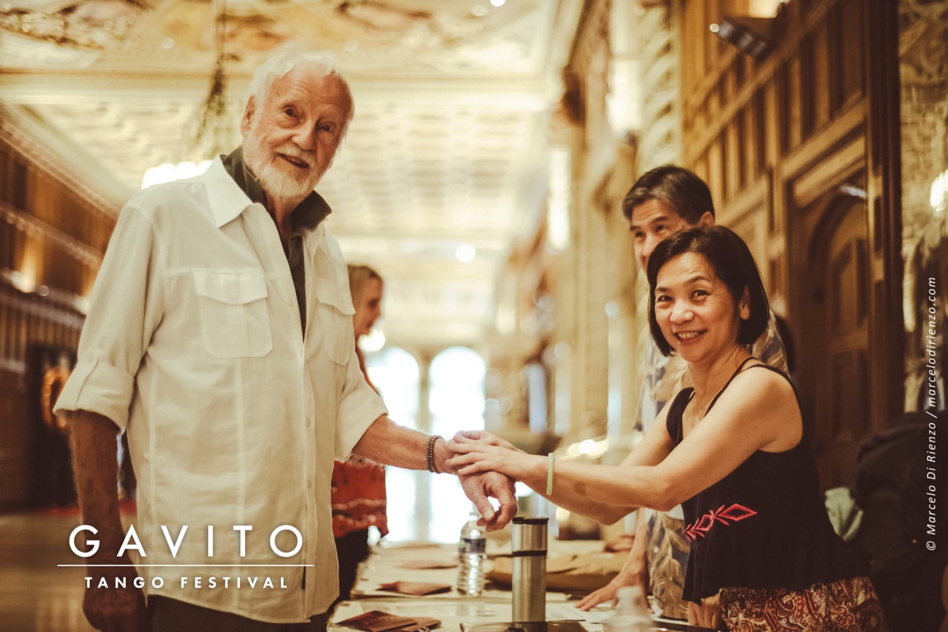 A cheerful waiter serves a smiling woman at a cozy café.