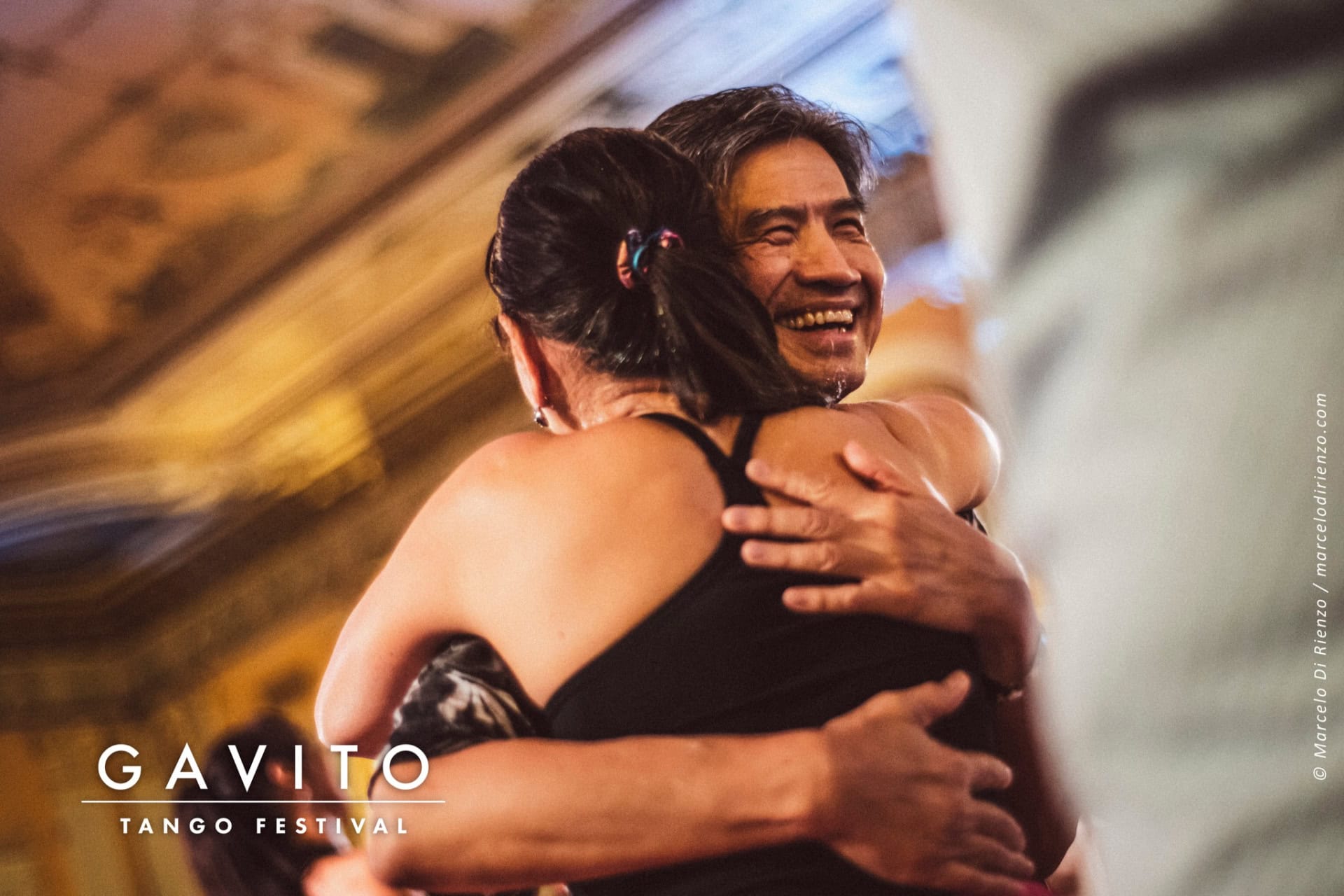 Two people warmly hugging in a joyful moment.