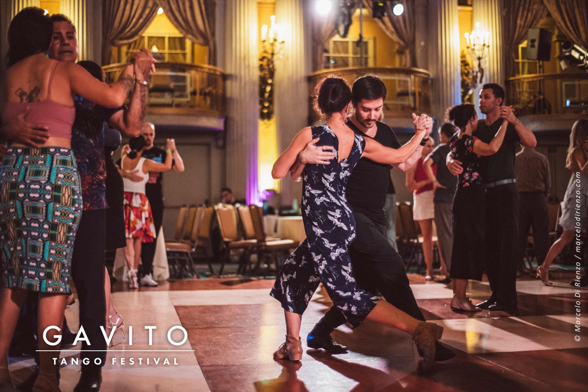 Couple passionately dancing tango in an elegant ballroom.