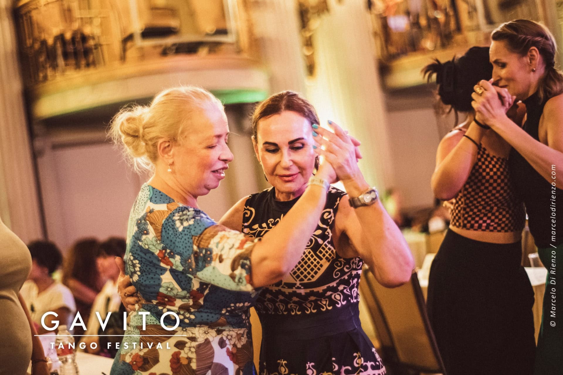 Two women joyfully celebrating together at a lively event.