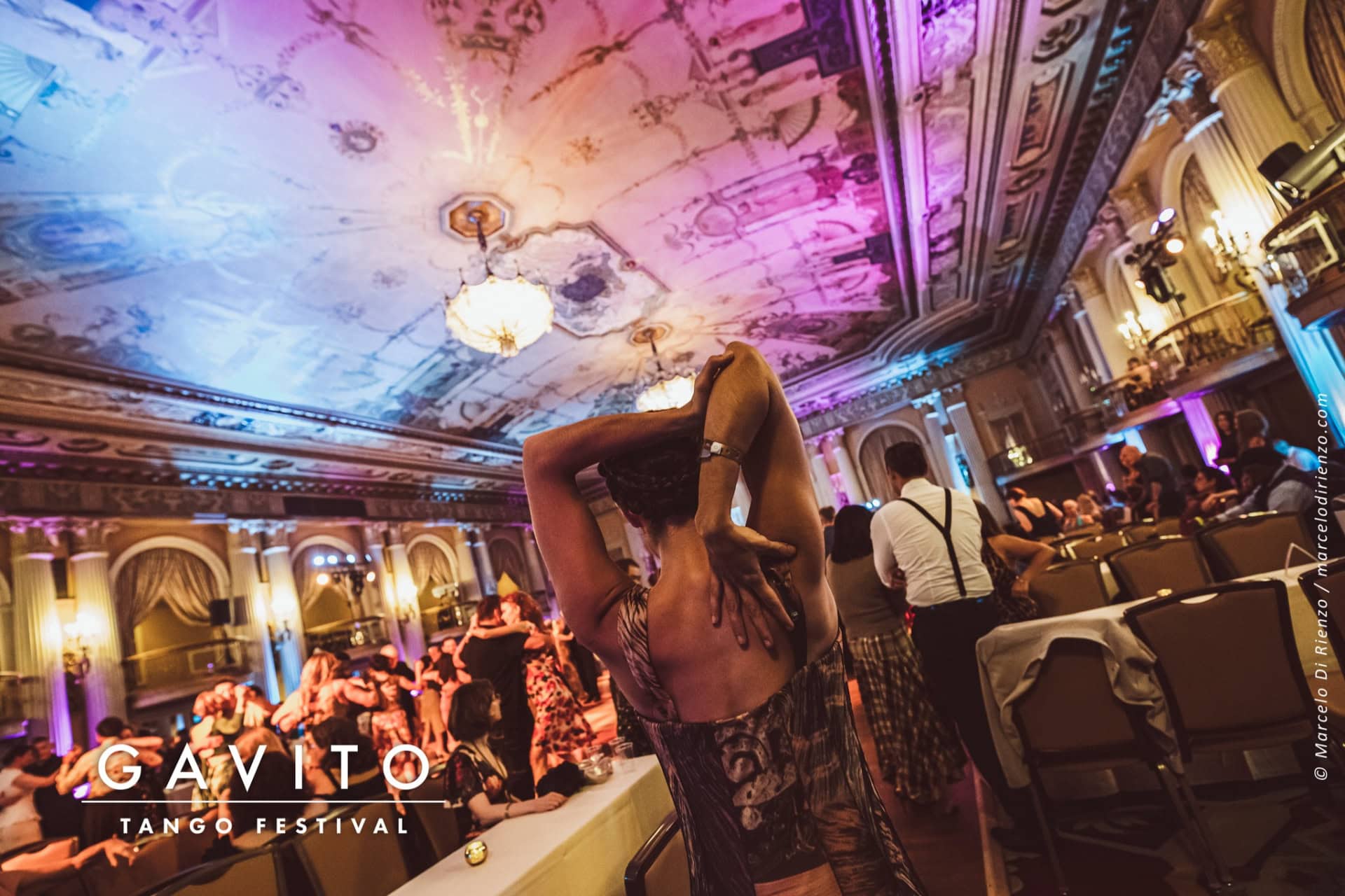 A lively nightclub scene with a performer and an enthusiastic crowd.