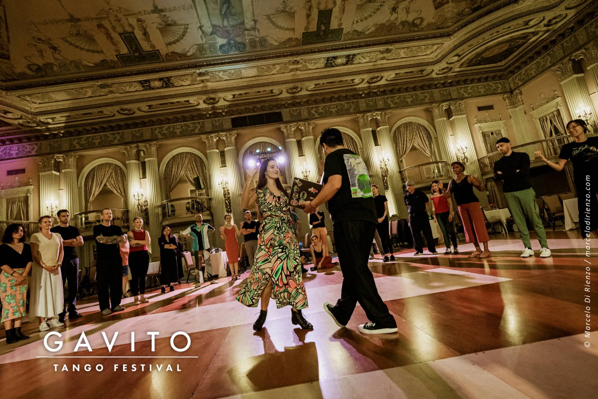 Elegant ballroom dancers performing in a grand, ornate hall.