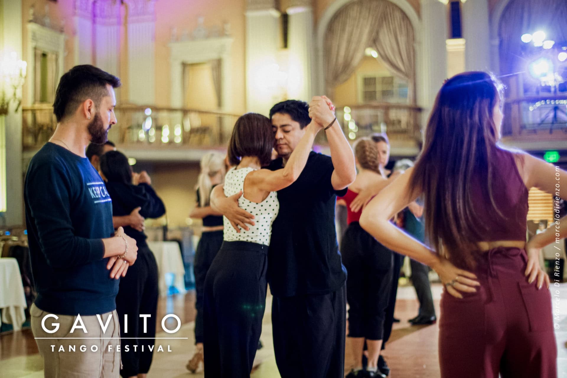 A joyful bride and groom celebrate at their wedding reception with guests.