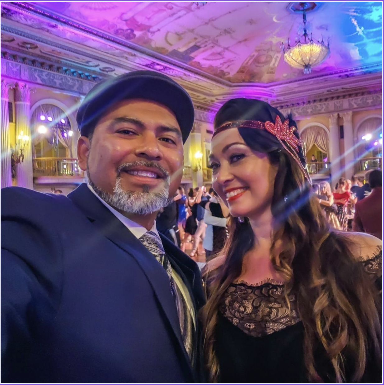 A smiling couple dressed elegantly at a festive event. A smiling couple dressed elegantly at a festive event.
